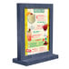 A Menu Solutions denim wood table tent with a drink menu displayed.