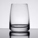 A close-up of a Stolzle juice glass on a reflective surface.