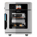 A silver Alto-Shaam Vector multi-cook oven with food in it.