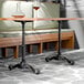 A black self-stabilizing cast iron table base with two columns, designed for standard height tables.