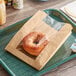 A Bagel in a Bagcraft Packaging Ecocraft bakery bag on a tray.