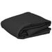 A stack of black folded rectangular black cloth table covers on a white background.