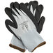 A pair of black and gray gloves with white trim on the wrist and gray trim on the fingers.