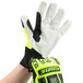 A hand wearing a lime green Cordova OGRE heavy duty work glove.