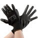 A pair of Cordova black gloves with black polyurethane palms.