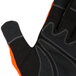 A medium Cordova warehouse glove with orange and black spandex and leather.