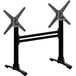 A pair of black metal FLAT Tech table stands with two black and silver X's.