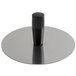 A circular stainless steel mold pack down tool with a black handle.