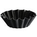 A black steel Matfer Bourgeat mini fluted brioche mold with wavy edges.