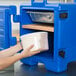 A woman pouring milk into a Cambro ThermoBarrier container.