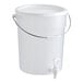 A 6-gallon clear round beverage dispenser with a lid, spigot, and carrying handle.