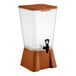 A 5-gallon brown beverage or juice dispenser with a spigot and a clear container.