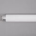 An Avantco T8 fluorescent light bulb with silver ends on a white surface with a black border.