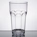 A clear Carlisle plastic tumbler on a table.