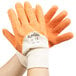 A pair of hands wearing Cordova Ruffian orange gloves with white and orange palms.