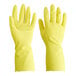 A pair of yellow Cordova rubber gloves with a raised finger.