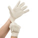 A person wearing Cordova Standard Weight cotton canvas work gloves.