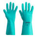 A gloved hand wearing a green Cordova Nitro glove.