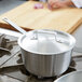 A Vollrath stainless steel cover for a pot.