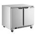 A stainless steel, low profile undercounter refrigerator with two doors and caster wheels.