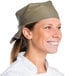 A smiling chef wearing an Intedge beige chef neckerchief.