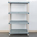 A MetroMax Q metal shelving unit with three white shelves with square holes.