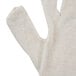 A pair of beige Cordova jersey gloves with a close up of the fabric.