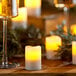 Sterno Amber flameless candles on a table with a glass of champagne.