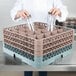 A woman using a Noble Products glass rack to hold glass bottles.