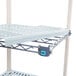 A MetroMax Q shelving add on unit with blue and white shelves and blue handles.