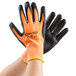 A pair of Cordova Hi-Vis orange gloves with black foam nitrile palm coating and black and orange tips.