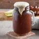 A glass of Narvon Old Fashioned Birch Beer with brown liquid and foam on top.