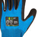 A close up of a Cordova Sapphire Blue work glove with black nitrile coating on the palm and a black and white logo.