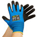 A pair of medium blue Cordova gloves with black palm coating.