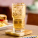 A glass of iced energy drink on a coaster.