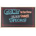 An Aarco oak-framed black chalk board on a counter with colorful writing that says "Come in for some great dinner specials."