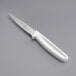 A Choice paring knife with a white handle.