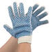 A pair of Cordova work gloves with blue and white dotted PVC coating.