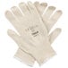 A pair of white Cordova Natural Cotton Work Gloves with blue nitrile coating on the palms.