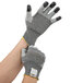 A pair of hands wearing Cordova Monarch gray and black dotted gloves.