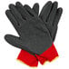 A pair of red gloves with dark gray latex coating and yellow accents.