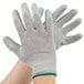 A pair of Cordova medium gloves with gray and green latex coating.