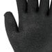 A close-up of a Cordova Monarch glove with black foam latex palm coating.