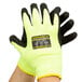 A pair of Cordova Monarch heavy duty work gloves with yellow and green sleeves and black foam latex palms.