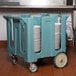 A blue Cambro dish dolly cart filled with stacked plates.