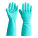 A gloved hand in a pair of green Cordova Nitrile gloves.