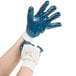 A pair of hands wearing Cordova blue gloves.