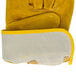 A close-up of a yellow and white Cordova warehouse glove with yellow leather palm coating.