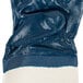 A blue Cordova warehouse glove with a white stripe on the cuff.