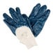 A pair of blue Cordova nitrile gloves with white and blue paint on them.